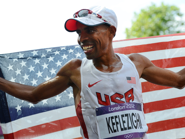 US's Mebrahtom Keflezighi celebrates after finishing fourth in the athletics event men's marathon during the London 2012 Olympic Games on August 12, 2012 in London.  (Photo credit ADRIAN DENNIS/AFP/GettyImages)