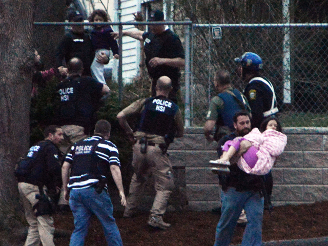  An agent carries a child away from an area where a suspect is hiding on Franklin St., on April 19, 2013 in Watertown, Massachusetts. (Photo by Darren McCollester/Getty Images) 