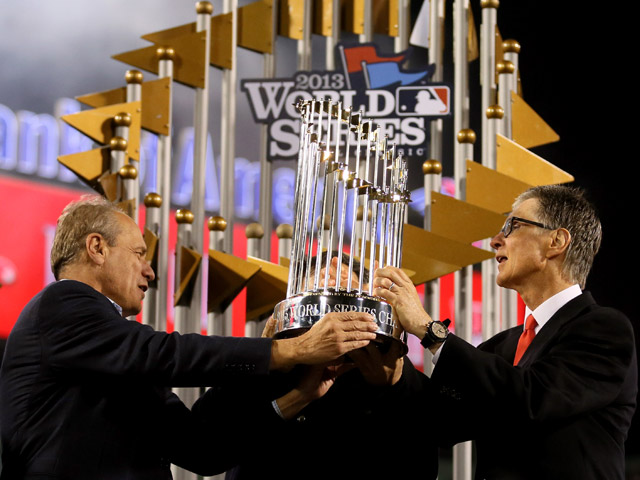 Owner of the Boston Red Sox John Henry is presented with the trophy after the Boston Red Sox defeated the St. Louis Cardinals 6-1 in Game Six of the 2013 World Series at Fenway Park on October 30, 2013 in Boston, Massachusetts. (Photo by Rob Carr/Getty Images)
