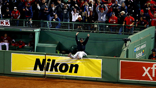 The police officer in the Boston Red Sox' bullpen reacts to David Ortiz's grand slam in Game 2 of the ALCS. (Photo by Al Bello/Getty Images)