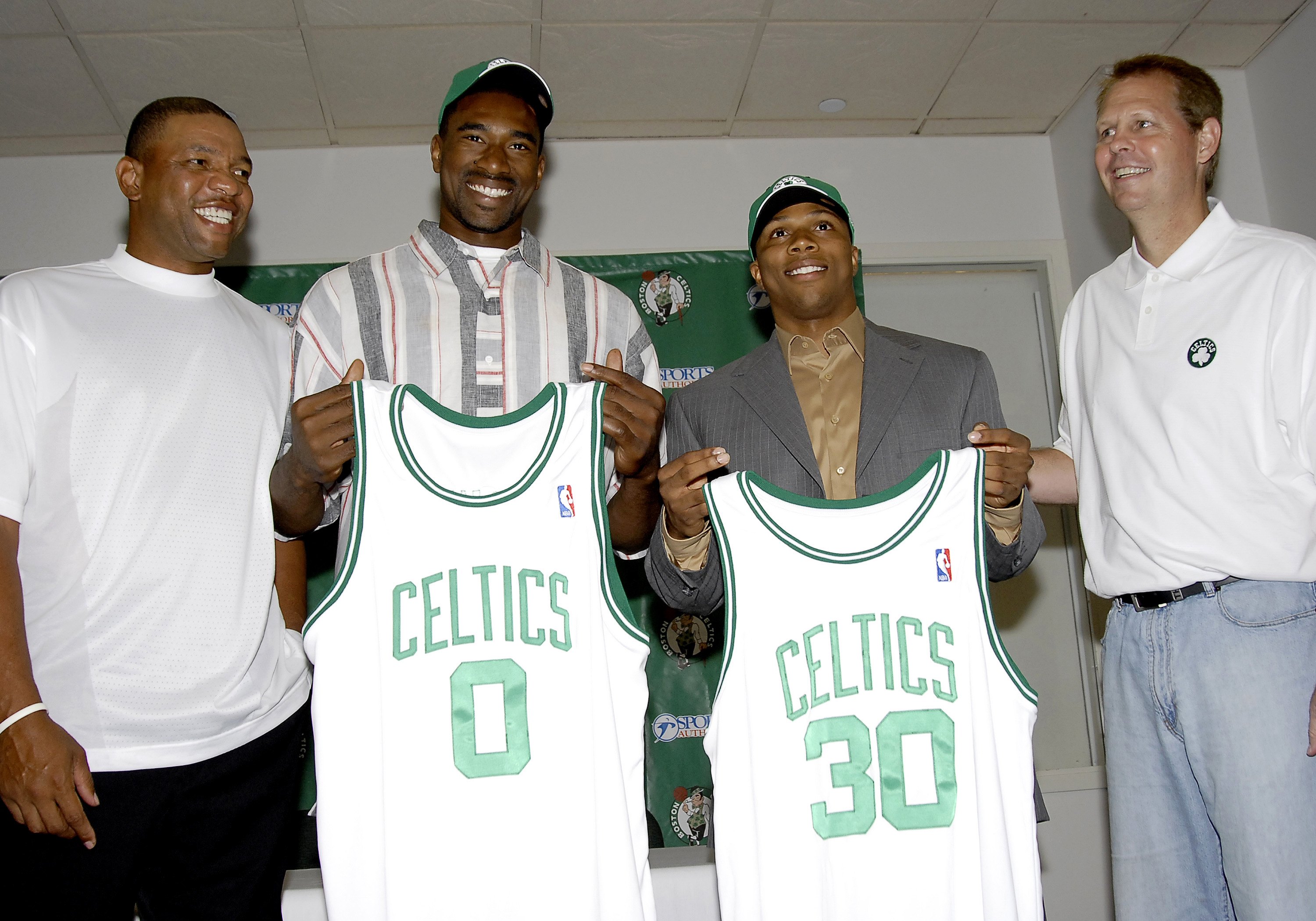 Doc Rivers and Danny Ainge pose with Sebastian Telfair and Leon Powe during a press conference in July 2006. (Photo by Brian Babineau/NBAE via Getty Images)
