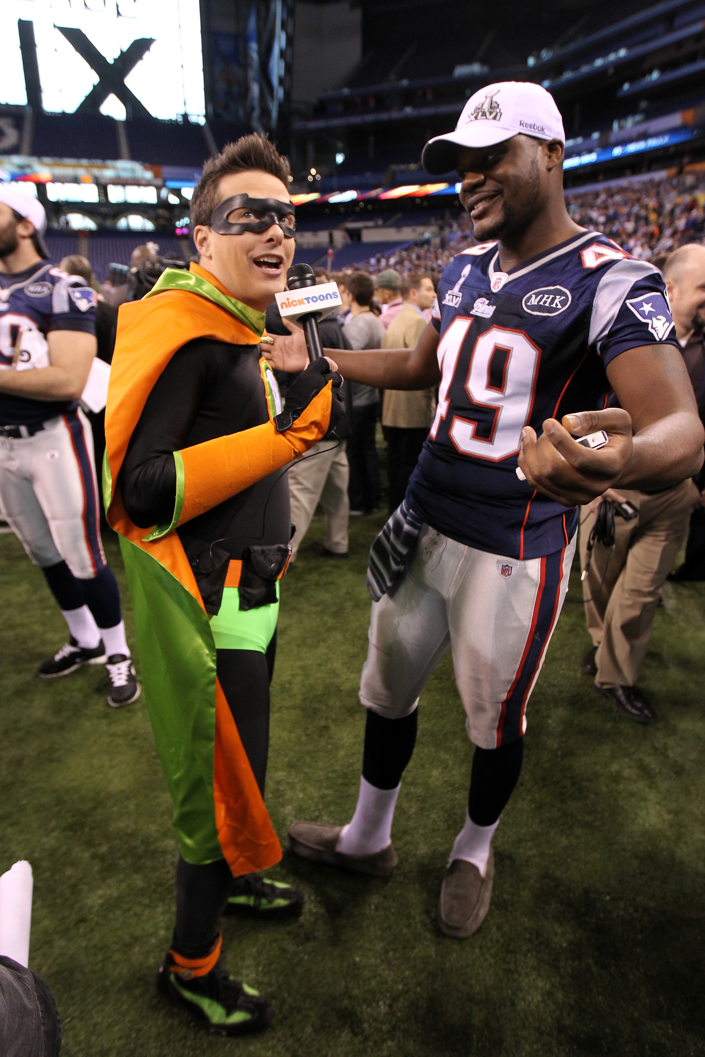 A member of the media dressed as a super hero interviews Markell Carter #49 of the New England Patriots during Media Day ahead of Super Bowl XLVI.  (Photo by Andy Lyons/Getty Images)