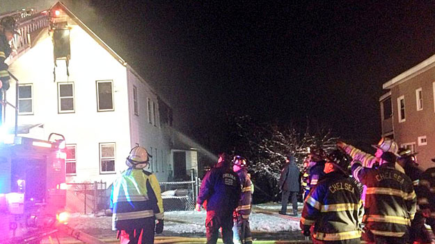 Firefighters tackle a fire Saturday night in Chelsea. (WBZ-TV)