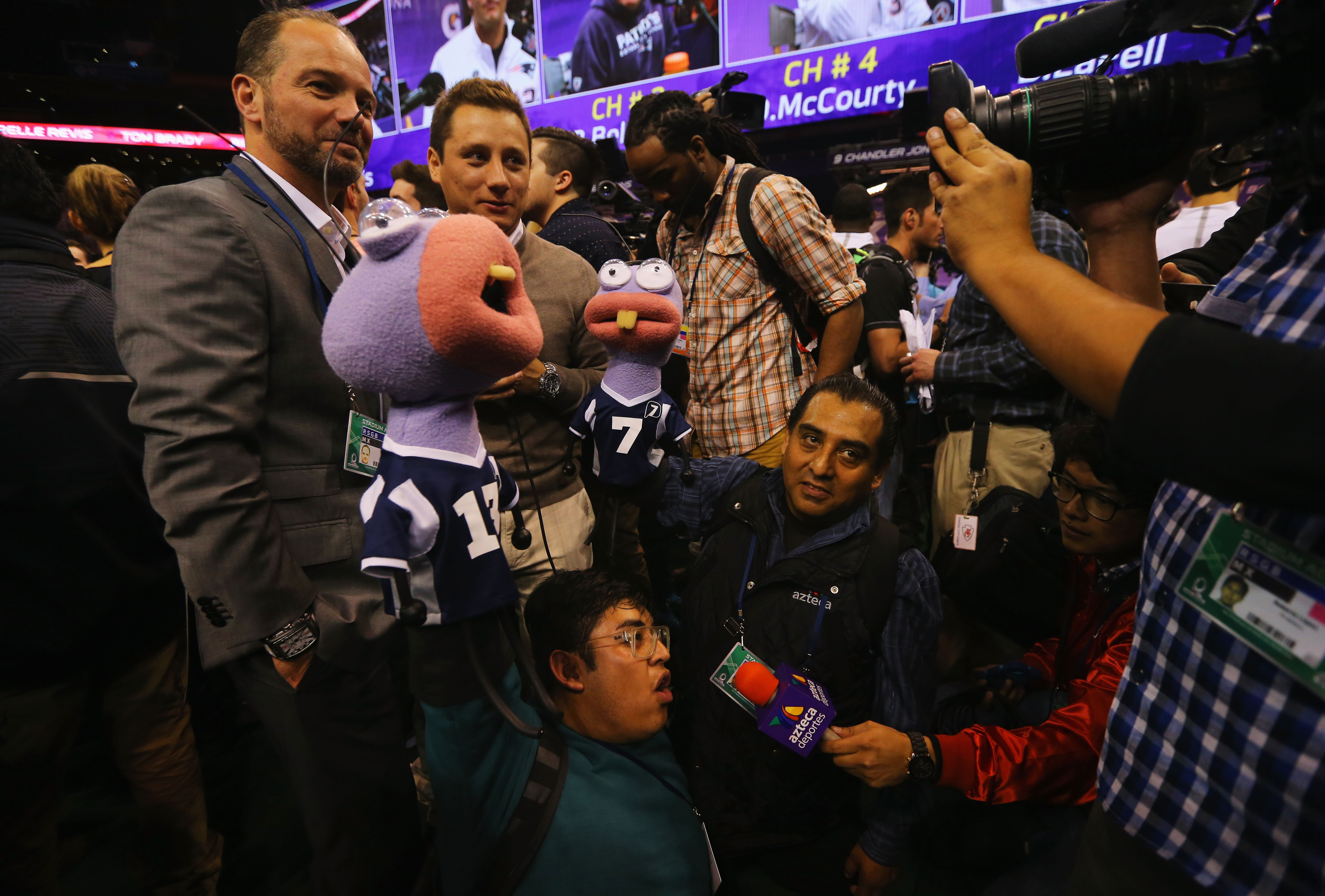 Media members from TV Azteca hold up puppets at Super Bowl XLIX Media Day inside U.S. Airways Center on January 27, 2015 in Phoenix, Arizona. (Photo by Elsa/Getty Images)