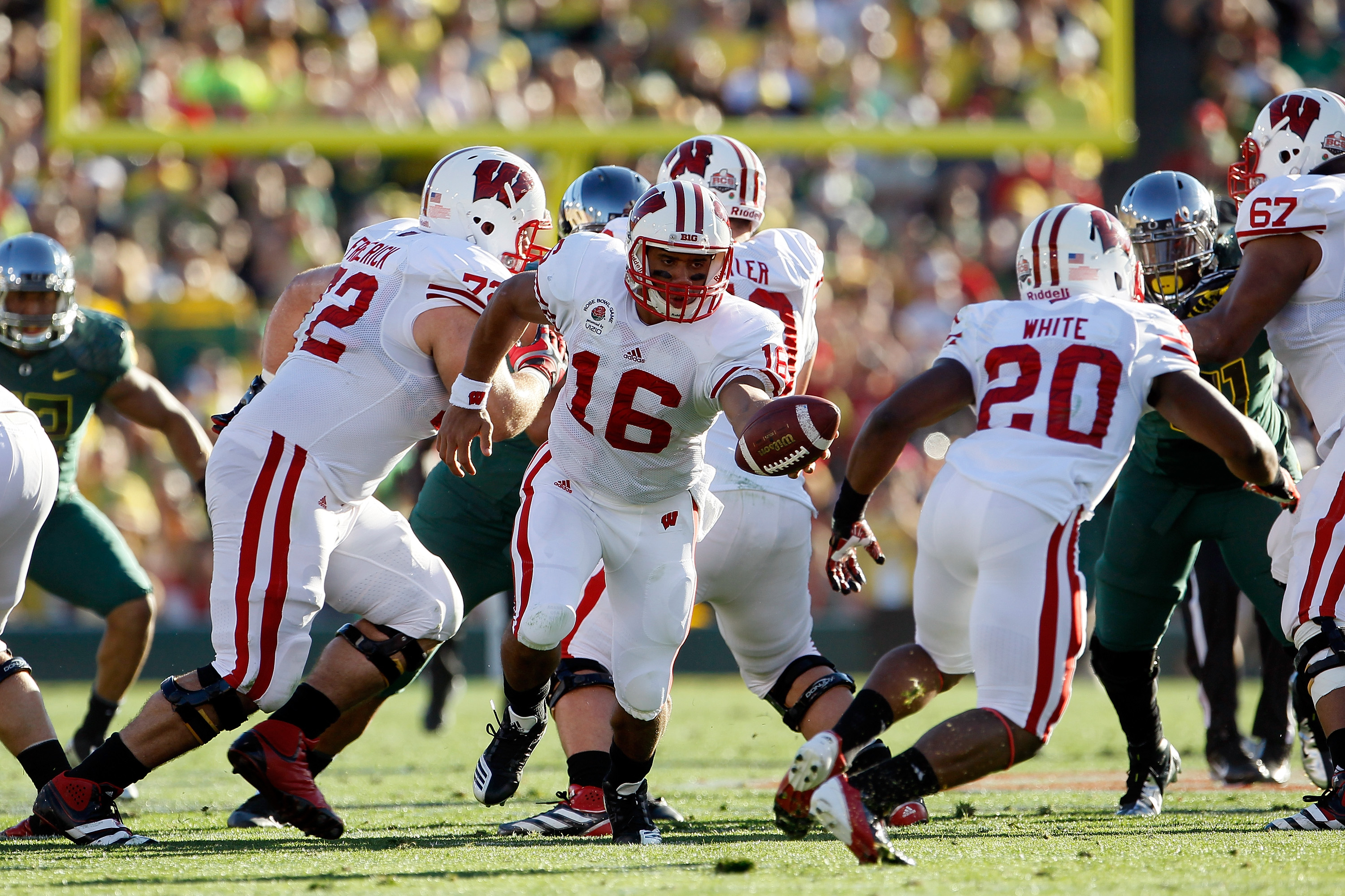 Wisconsin Quarterback Russell Wilson fakes a handoff to running back James White against Oregon Ducks in the 98th Rose Bowl.  (Photo by Jeff Gross/Getty Images)