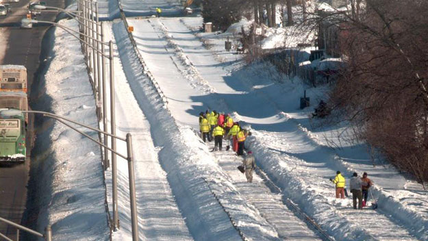 Workers clear Red Line tracks of snow and ice near Water Street in Quincy. (Photo credit MBTA)