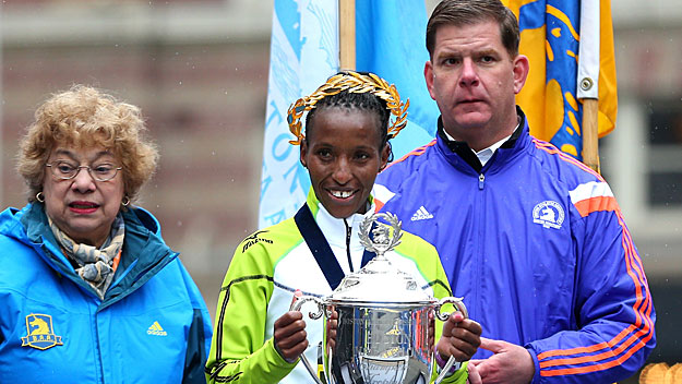 Caroline Rotich of Kenya poses with the trophy and Mayor Marty Walsh after winning the 119th Boston Marathon on April 20, 2015. (Photo by Jim Rogash/Getty Images)