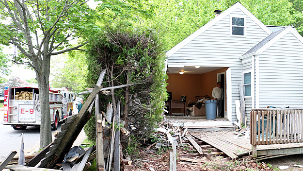 An SUV drove into a New Bedford home on Saturday. (Photo by David Curran/SatelliteNewsService.com)