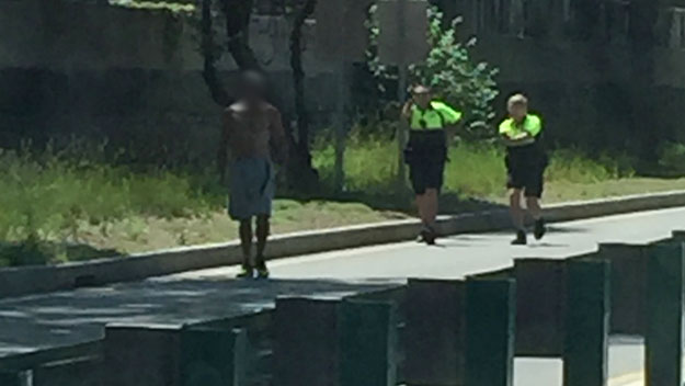Police officers following man with knife near Storrow Dr. (Credit: Dr. Elizabeth Chabner Thompson)