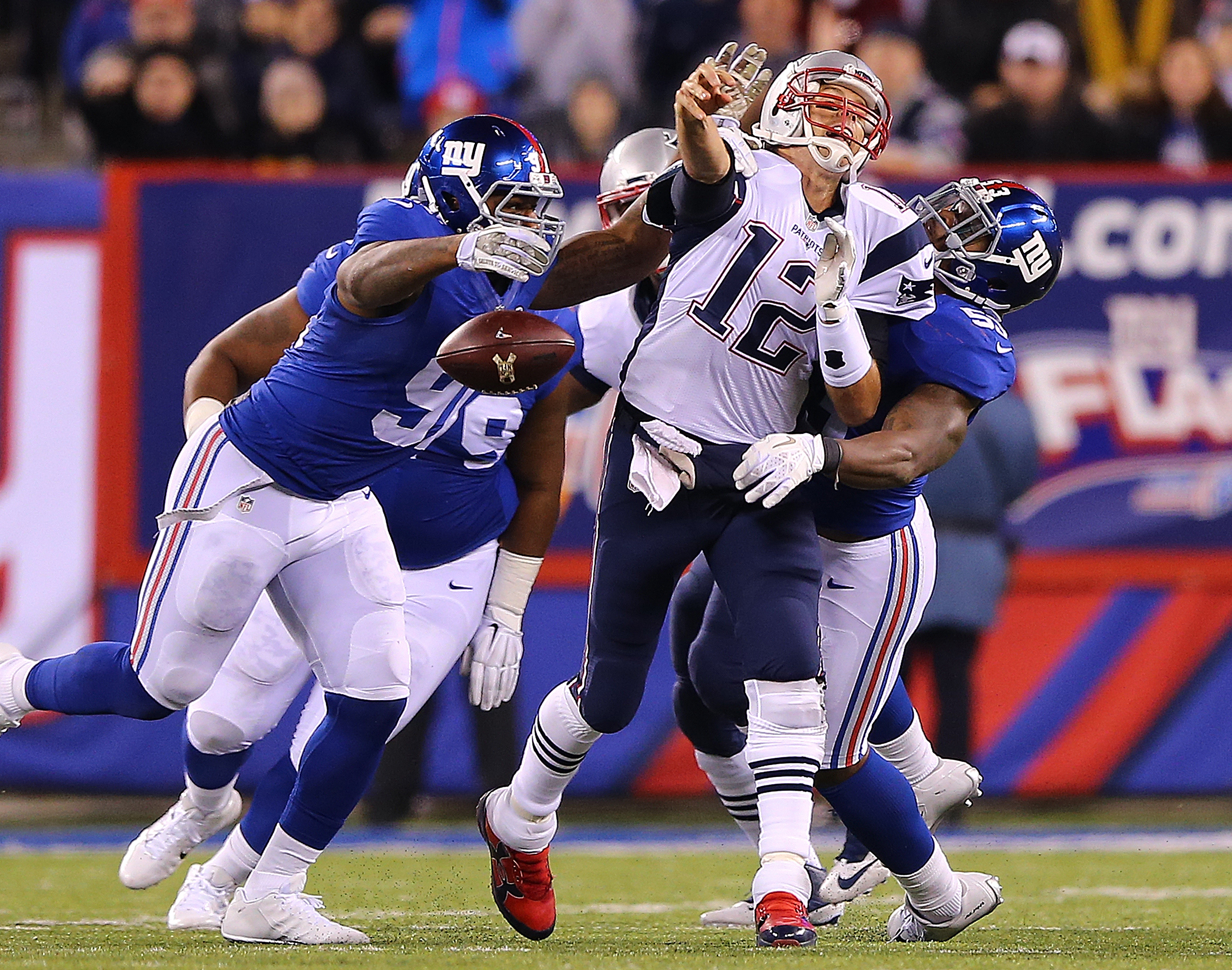 EAST RUTHERFORD, NJ - NOVEMBER 15: Tom Brady #12 of the New England Patriots Tom Brady fumbles the ball against the New York Giants. (Photo by Elsa/Getty Images)