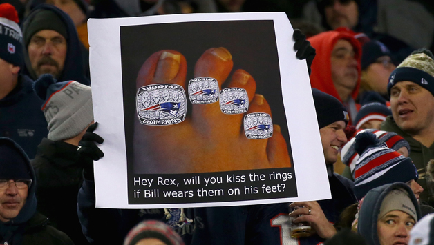 A Patriots fan holds a sign mocking Rex Ryan. (Photo by Jim Rogash/Getty Images)