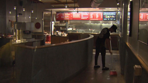 A worker inside the Cleveland Circle Chipotle that was shut down (WBZ-TV)
