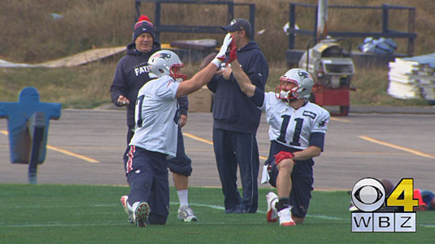 Patriots tight end Rob Gronkowski high-fives receiver Julian Edelman as they both hit the practice field on Friday, December 11. (WBZ-TV)