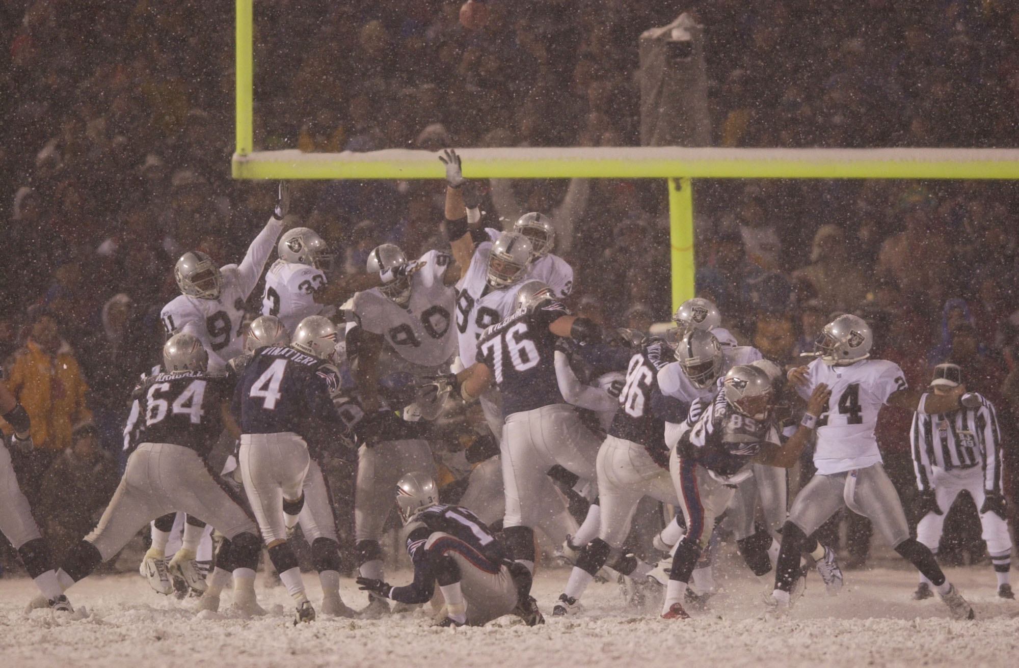 Adam Vinatieri of the New England Patriots kicks the game-winning field goal against the Oakland Raiders during the AFC playoff game at Foxboro Stadium in Foxboro, Massachusetts. (Photo by Ezra Shaw/Getty Images)