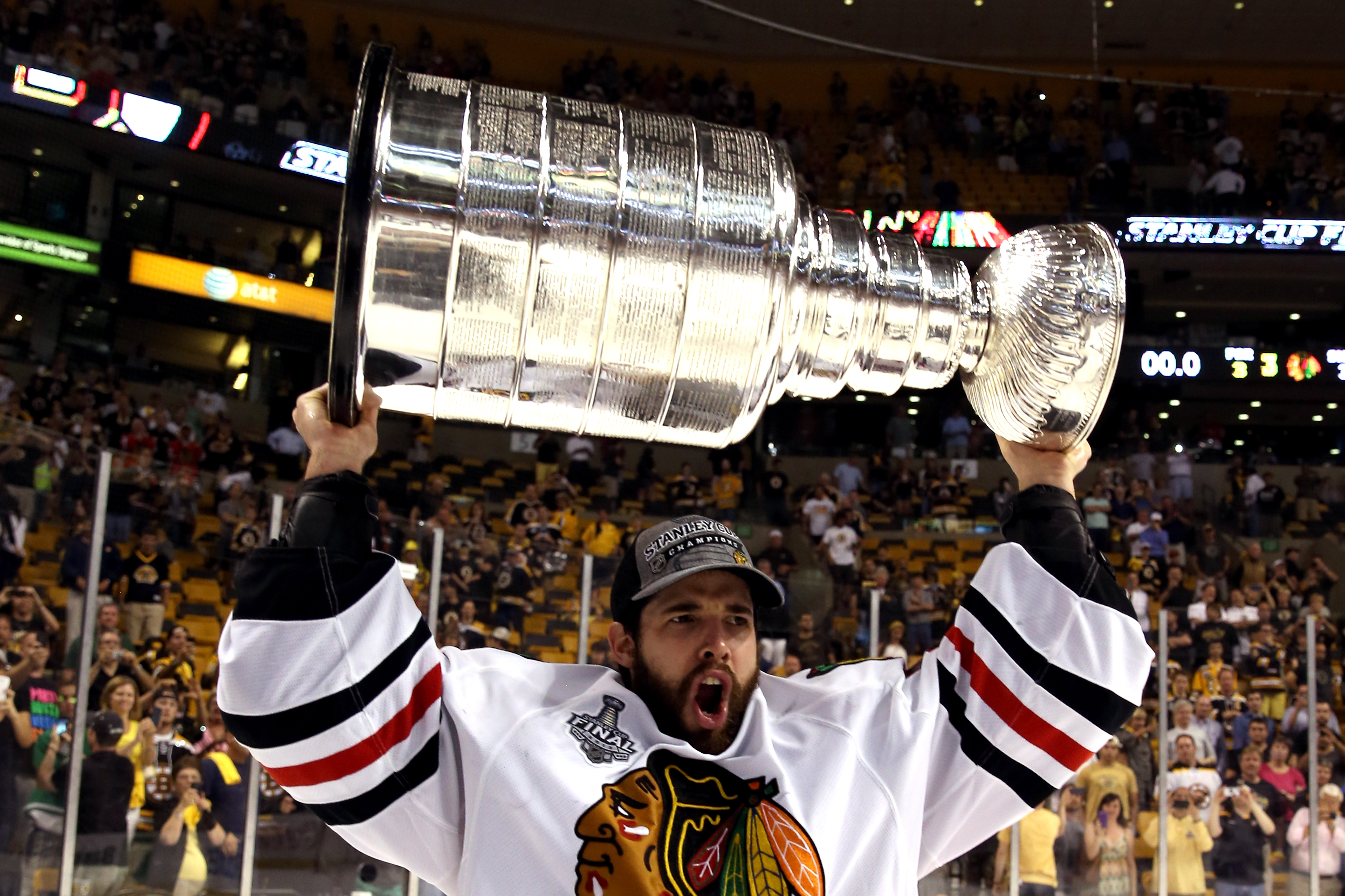 Corey Crawford hoisted the Stanley Cup on the TD Garden Ice, outplaying Tuukka Rask at a fraction of the cost. (Photo by Bruce Bennett/Getty Images)