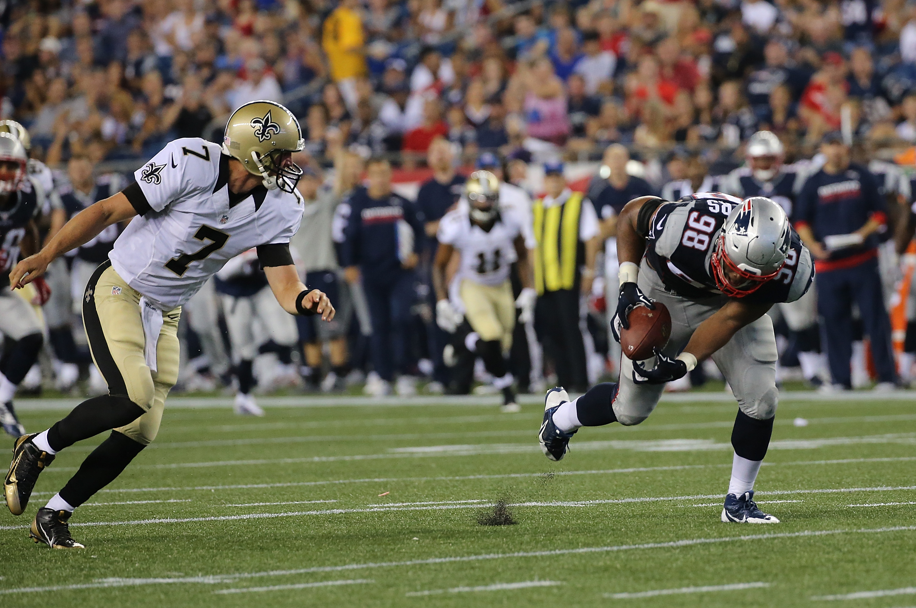 Trey Flowers #98 of the New England Patriots recovers a fumble as Luke McCown #7 of the New Orleans Saints looks on in the second half of a preseason game at Gillette Stadium on August 11, 2016. (Photo by Jim Rogash/Getty Images)