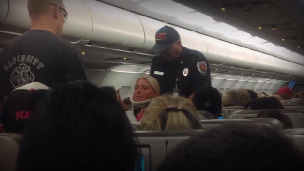 A JetBlue passenger receives medical attention following a turbulent flight out of Boston. (CBS)