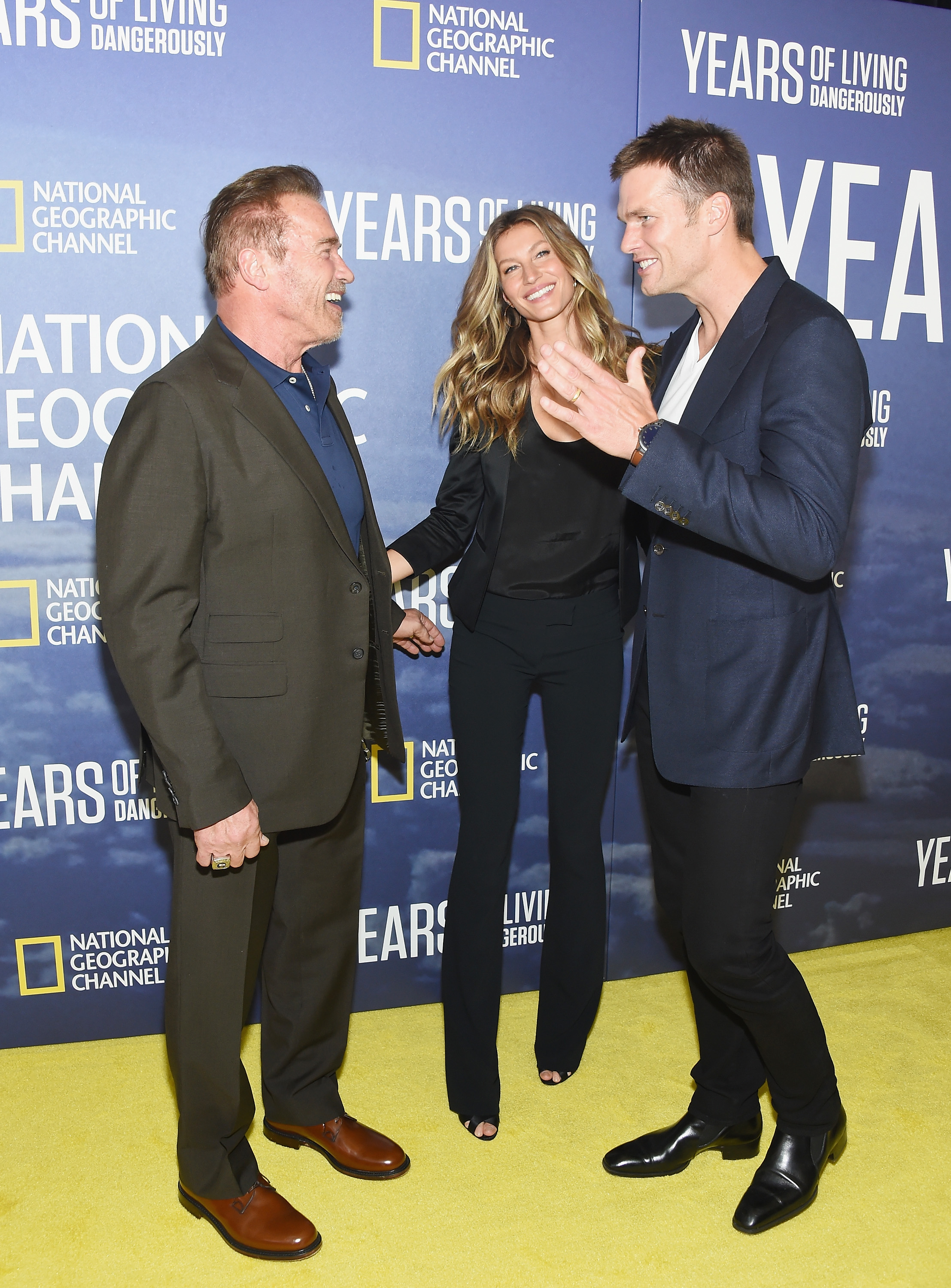 Arnold Schwarzenegger with Tom Brady and Gisele Bundchen (Photo by Michael Loccisano/Getty Images)