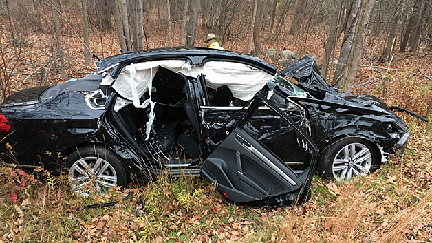 A woman was trapped in this car overnight after it rolled off Route 27 in New Hampshire. (Epping Fire Department)