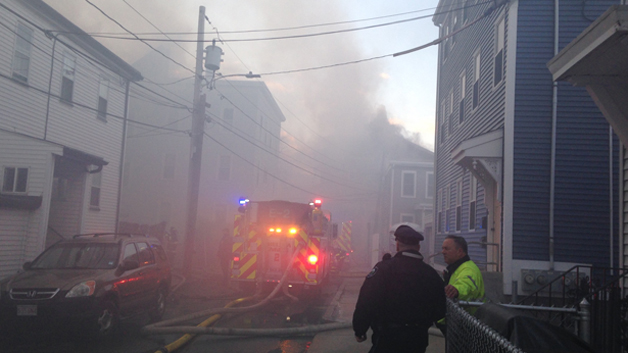Smoke fills a Cambridge neighborhood as several buildings have caught fire. (WBZ-TV)