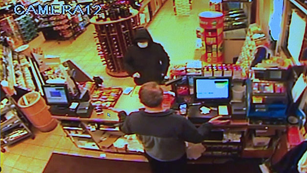 Surveillance footage shows a man robbing White Rose Pantry in Easton. (WBZ-TV)