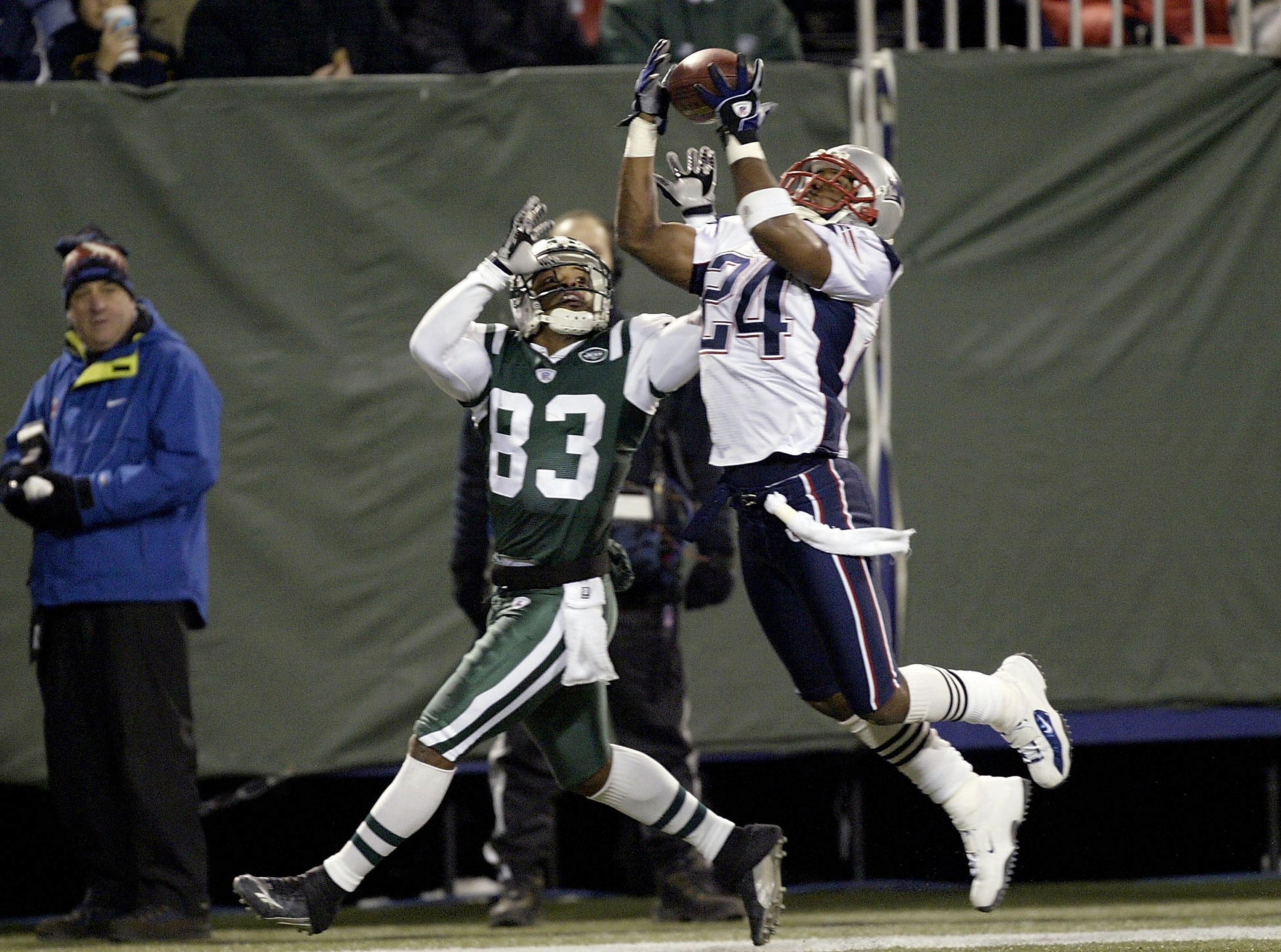 Ty Law of the New England Patriots intercepts a pass intended for Santana Moss of the New York Jets on December 20, 2003. The Patriots won 21-16. (Photo by Ezra Shaw/Getty Images)