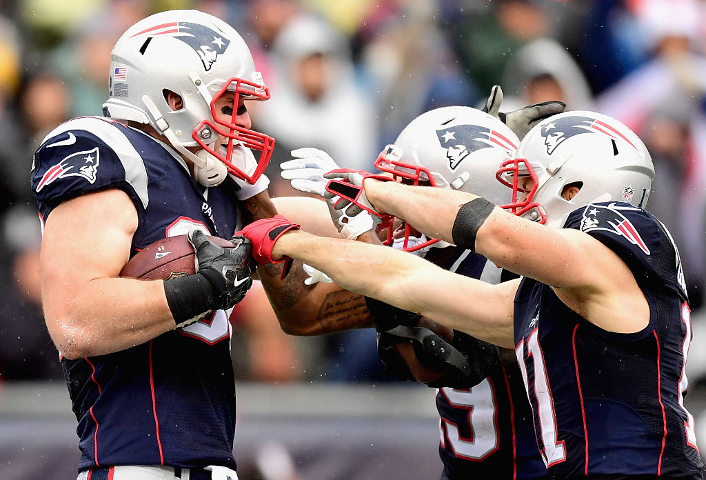 Julian Edelman and Malcolm Mitchell celebrate with Matt Lengel. (Photo by Billie Weiss/Getty Images)