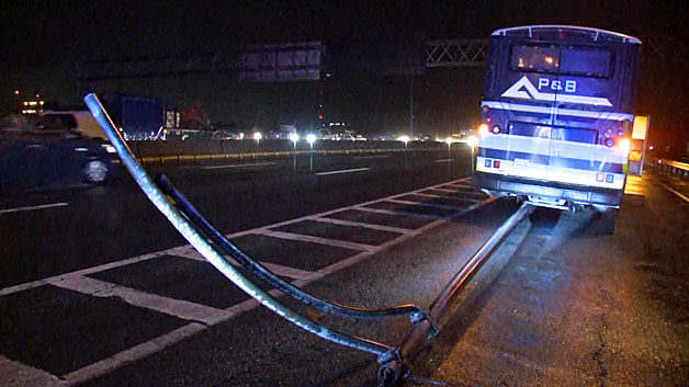 This bus hit a light pole lying in the road, sending part of it flying in the air on I-93, Jan. 12, 2017 .(WBZ-TV)
