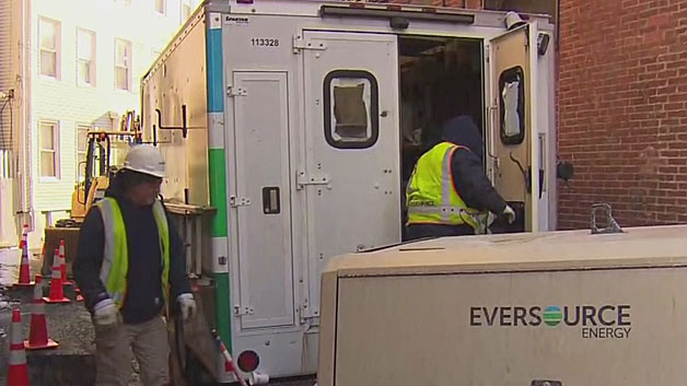 Eversource crews work to repair underground power lines Monday morning in East Boston. (WBZ-TV)