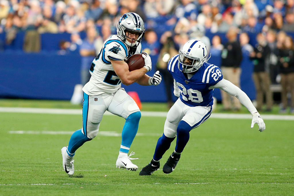 Christian McCaffrey #22 of the Carolina Panthers runs the ball and is tackled by Briean Boddy-Calhoun #28 of the Indianapolis Colts during the third quarter at Lucas Oil Stadium on December 22, 2019 in Indianapolis, Indiana. 