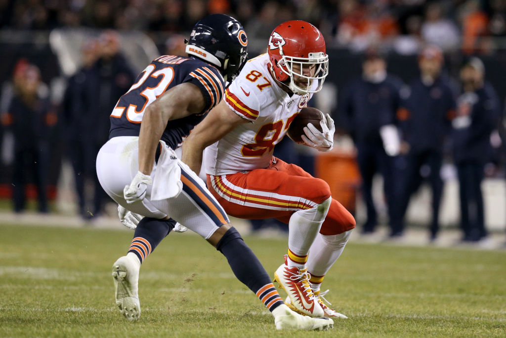 Travis Kelce #87 of the Kansas City Chiefs runs with the ball against Kyle Fuller #23 of the Chicago Bears in the fourth quarter at Soldier Field on December 22, 2019 in Chicago, Illinois. 