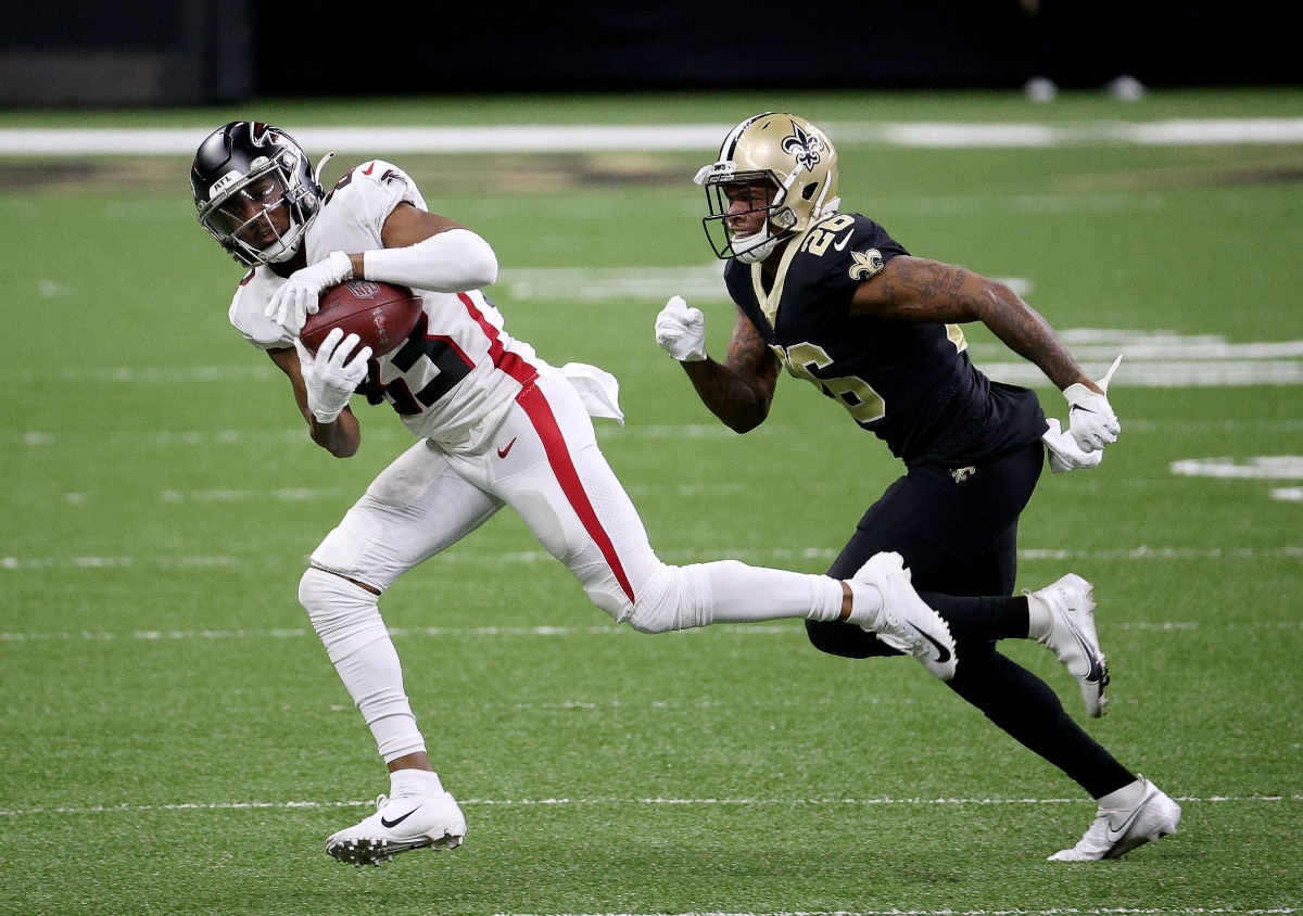 Russell Gage #83 of the Atlanta Falcons makes the catch as P.J. Williams #26 of the New Orleans Saints defends in the second quarter at Mercedes-Benz Superdome on November 22, 2020 in New Orleans, Louisiana